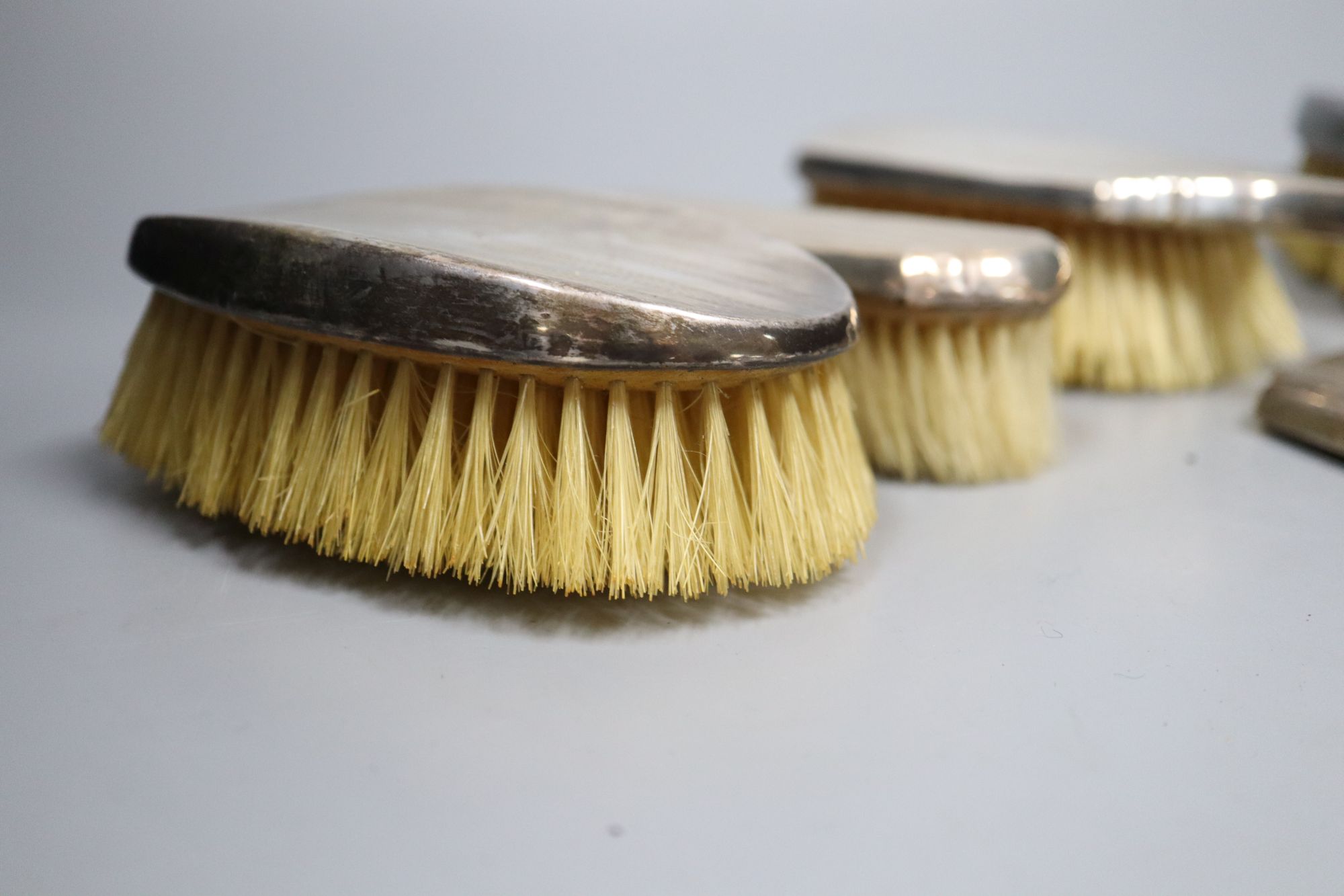 Seven various silver mounted hair and clothes brushes, one a.f.